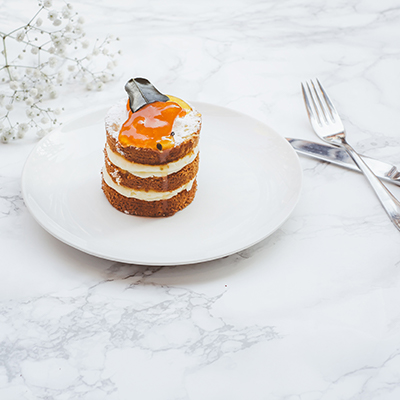 classy triple layer cream cake with apricot glaze and silverware